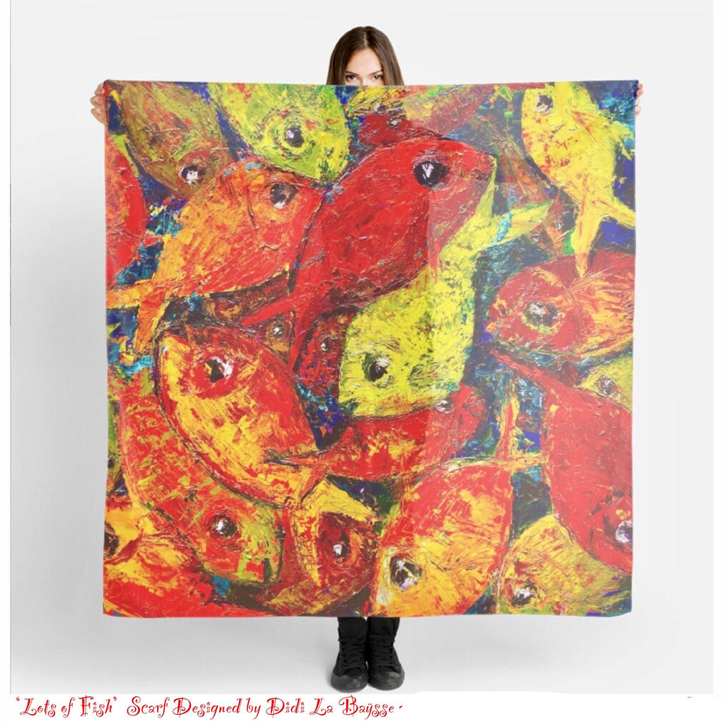 Person holding a colorful scarf with fish design